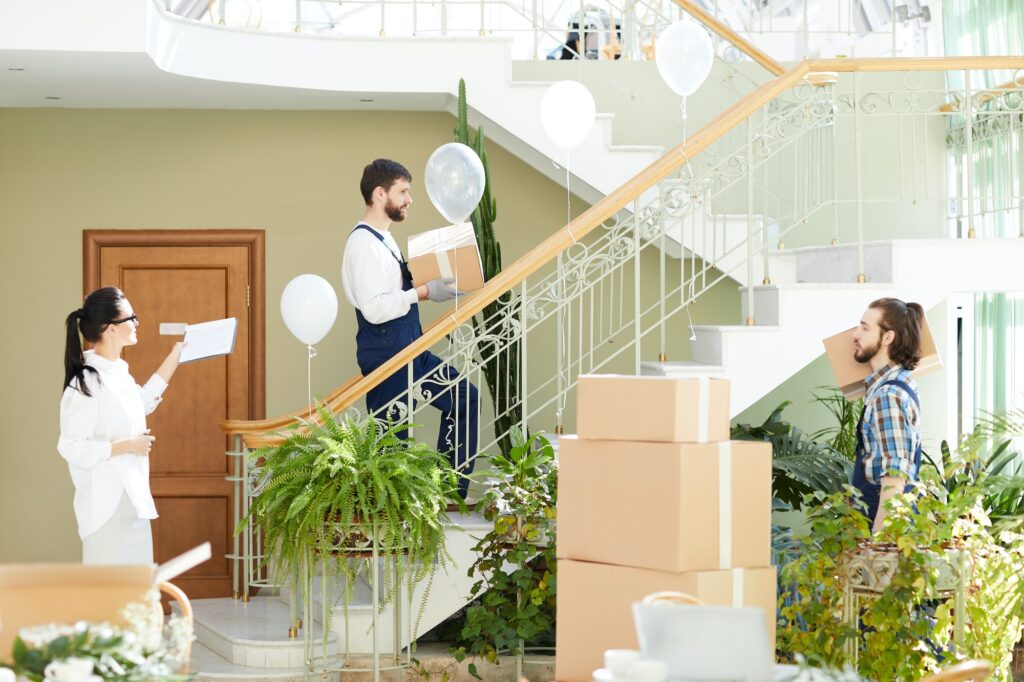 Stylish interior designer managing movers